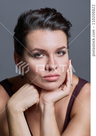 Headshot portrait of young woman with hairstyle makeup on gray background 110208822