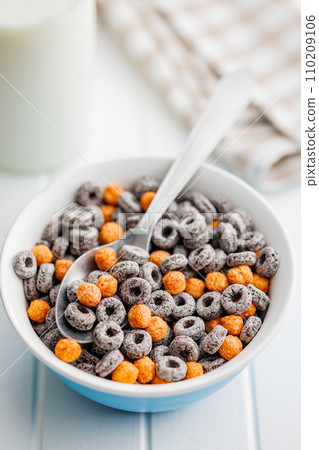 Sweet breakfast cereals in bowl on white table. 110209106