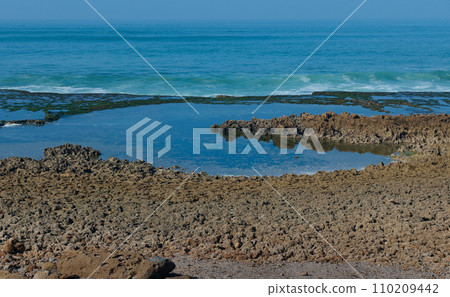 A bay formed by splashing waves and crashing on headland. Beauty in nature. Nature seascape background 110209442