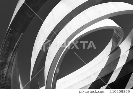 Striking monochrome architectural feature with sweeping curves and a dynamic interplay of light and shadow Striking monochrome architectural feature with sweeping curves and a dynamic interplay of light and shadow 110209869