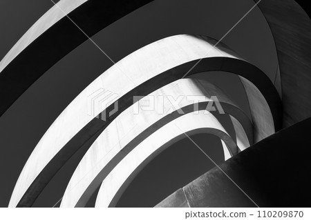 Striking monochrome architectural feature with sweeping curves and a dynamic interplay of light and shadow 110209870