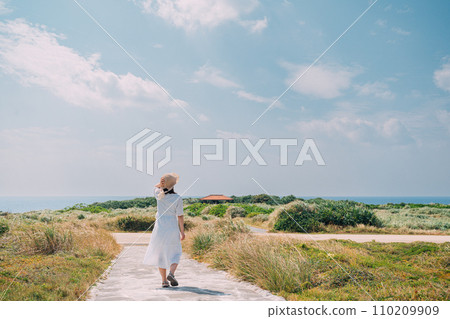 A woman relaxing on the coast 110209909