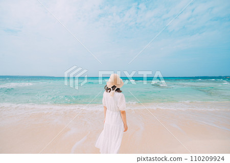 A woman relaxing on a beautiful tropical beach 110209924