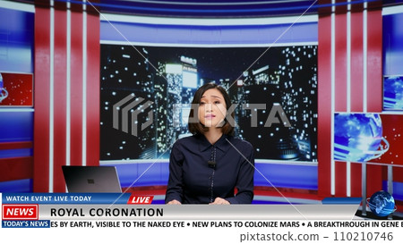 TV broadcaster talks about royal coronation and presents important event followed by people worldwide. Asian presenter going live on tv program to introduce new king, late night monarchy news. 110210746