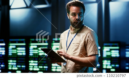 Engineer doing monitoring in server hub responsible with intense data computations demanding high capacity, scalable, error free network to effectively support artificial intelligence workloads Engineer doing monitoring in server hub responsible with intense data computations demanding high capacity, scalable, error free network to effectively support artificial intelligence workloads 110210797