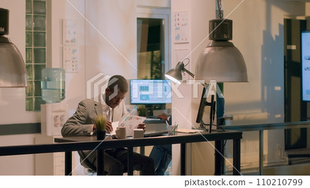 Employee fed up with monotonous work in office during nightshift, throwing paperwork clipboard before going out to take break. Businessman annoyed with tedious tasks, in need of relaxation Employee fed up with monotonous work in office during nightshift, throwing paperwork clipboard before going out to take break. Businessman annoyed with tedious tasks, in need of relaxation 110210799