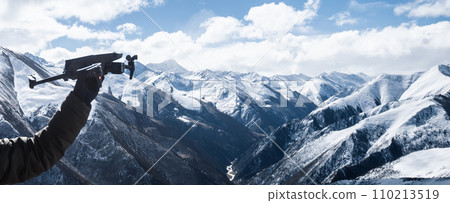 flying drone on snowing high altitude mountains flying drone on snowing high altitude mountains 110213519
