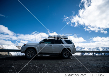 Driving car on snowing high altitude mountain trail, China 110213520