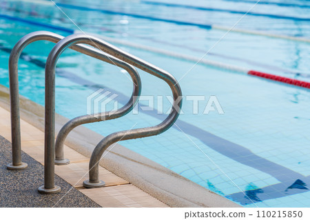competition pool with blue water and marked swimming lanes with stair competition pool with blue water and marked swimming lanes with stair 110215850