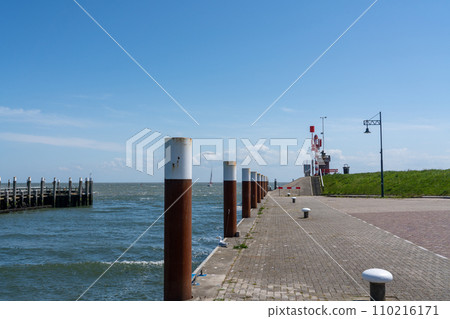 By the sea along the pier with a light house 110216171