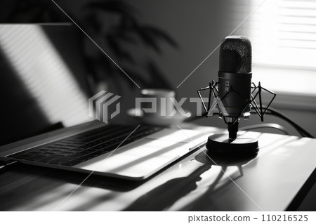 influencer or content creator recording a video podcast or YouTube video, studio microphone. with laptop .generative ai 110216525