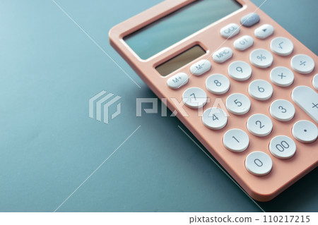 pastel calculator and white button on blue background, business and finance accounting concept pastel calculator and white button on blue background, business and finance accounting concept 110217215