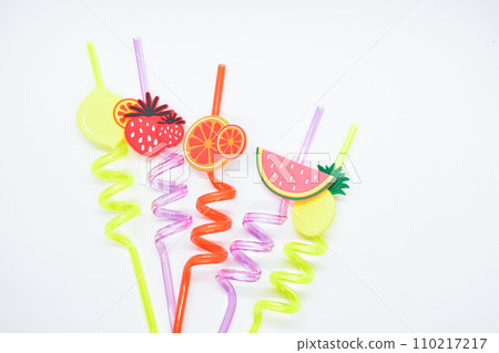 close up colorful fruit drinking staws on white background 110217217