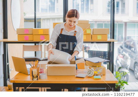 Online small business owners are packing their ordered products into the boxes for their customers based on the concept of online shopping - online shopping. Online small business owners are packing their ordered products into the boxes for their customers based on the concept of online shopping - online shopping. 110219477