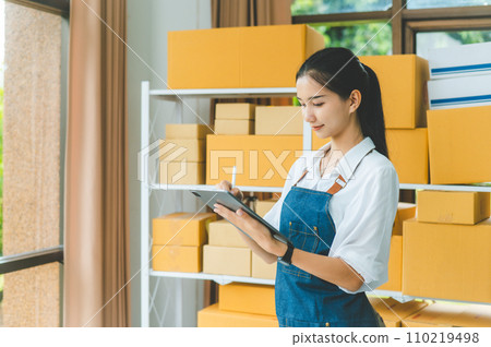 Small business owners online check stock on shelves, to calculate costs or check products for customers.concept shopping online Small business owners online check stock on shelves, to calculate costs or check products for customers.concept shopping online 110219498