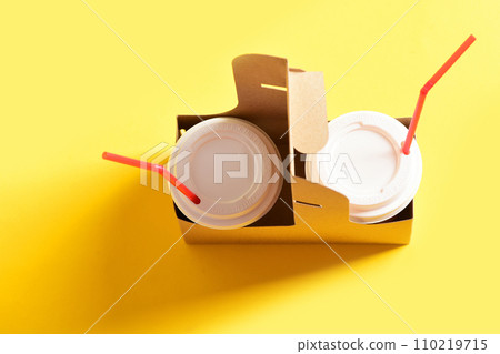 Cups for caffeine drinks with white covers and red straws 110219715