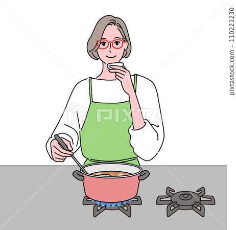 Middle-aged woman tasting food while cooking 110221230