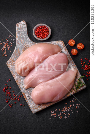 Fresh chicken fillet on a dark concrete table with spices and herbs 110221393