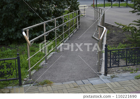 Shiny metal ramp for the disabled. A special path for the disabled. Shiny metal ramp for the disabled. A special path for the disabled. 110221690