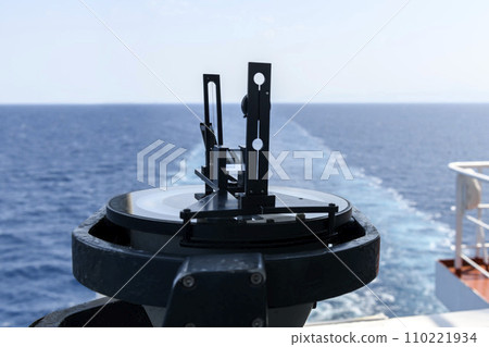 Azimuth ring on gyro compass. Direction finder on the navigational bridge. Azimuth vane. Bearing finder. Navigational equipment. Azimuth ring on gyro compass. Direction finder on the navigational bridge. Azimuth vane. Bearing finder. Navigational equipment. 110221934