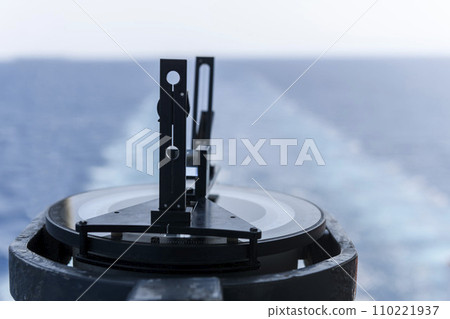 Azimuth ring on gyro compass. Direction finder on the navigational bridge. Azimuth vane. Bearing finder. Navigational equipment. Azimuth ring on gyro compass. Direction finder on the navigational bridge. Azimuth vane. Bearing finder. Navigational equipment. 110221937