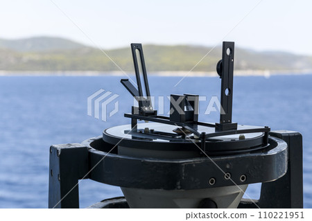 Azimuth ring on gyro compass. Direction finder on the navigational bridge. Azimuth vane. Bearing finder. Navigational equipment. Azimuth ring on gyro compass. Direction finder on the navigational bridge. Azimuth vane. Bearing finder. Navigational equipment. 110221951