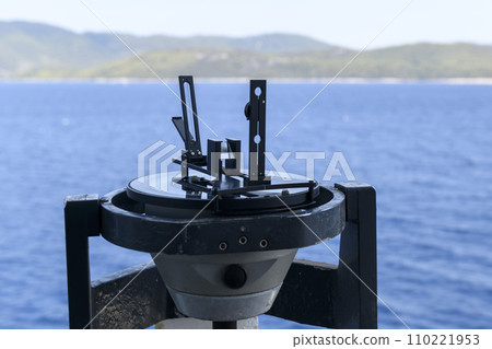Azimuth ring on gyro compass. Direction finder on the navigational bridge. Azimuth vane. Bearing finder. Navigational equipment. Azimuth ring on gyro compass. Direction finder on the navigational bridge. Azimuth vane. Bearing finder. Navigational equipment. 110221953