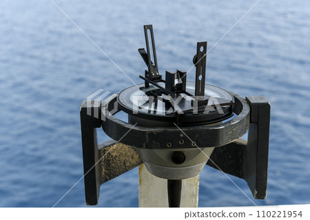 Azimuth ring on gyro compass. Direction finder on the navigational bridge. Azimuth vane. Bearing finder. Navigational equipment. Azimuth ring on gyro compass. Direction finder on the navigational bridge. Azimuth vane. Bearing finder. Navigational equipment. 110221954