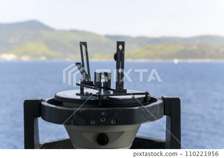 Azimuth ring on gyro compass. Direction finder on the navigational bridge. Azimuth vane. Bearing finder. Navigational equipment. Azimuth ring on gyro compass. Direction finder on the navigational bridge. Azimuth vane. Bearing finder. Navigational equipment. 110221956