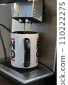 Coffee flows from a fully automatic coffee machine into a coffee pot 110222275