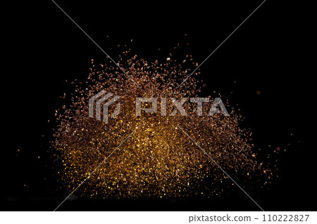 Ground Coffee roasted powder dust fly explosion, Coffee crushed ground float pouring. Roasted Coffee powder ground dust splash explosion in mid Air. Black background Isolated gold bokeh 110222827