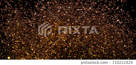 Ground Coffee roasted powder dust fly explosion, Coffee crushed ground float pouring. Roasted Coffee powder ground dust splash explosion in mid Air. Black background Isolated gold bokeh 110222828