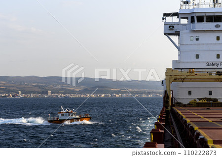Pilot boat and cargo vessel at sea. Pilot embarkation. Pilotage. 110222873