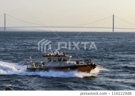 Pilot boat and cargo vessel at sea. Pilot embarkation. Pilotage. 110222886