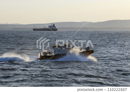 Pilot boat and cargo vessel at sea. Pilot embarkation. Pilotage. 110222887