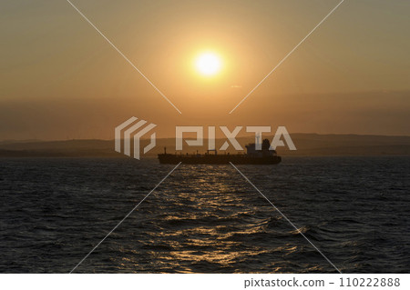 Cargo vessel at sea. Bulk carrier. Dry cargo ship at sunset. 110222888