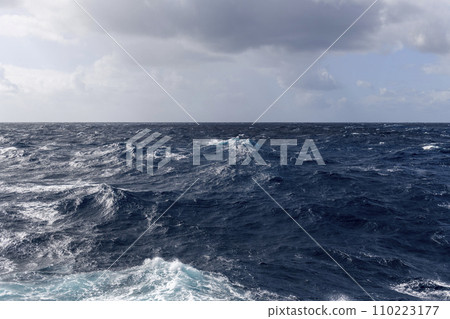 Beautiful seascape - waves and sky with clouds with beautiful lighting. Stormy sea, Bad weather. Gale. Rough sea. Beaufort scale 6. Beautiful seascape - waves and sky with clouds with beautiful lighting. Stormy sea, Bad weather. Gale. Rough sea. Beaufort scale 6. 110223177