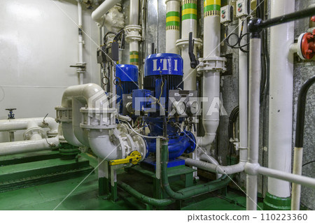 Water pump on ship. Engine room interior on big vessel. Water pump on ship. Engine room interior on big vessel. 110223360