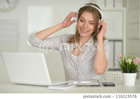 Young beautiful girl working on her laptop 110223576