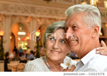 old couple posing on blurred casino background old couple posing on blurred casino background 110223578