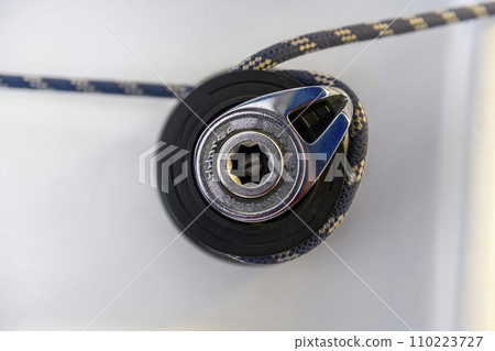 Yacht winch with rope on sailing boat. Top view. Yachting concept. Yacht winch with rope on sailing boat. Top view. Yachting concept. 110223727
