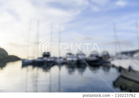 Blurred background sailing yachts in marina. Summer abstract defocused background. Yachting concept. 110223762
