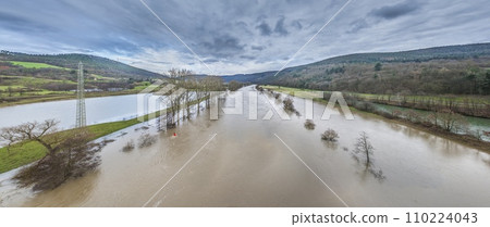 Drone image of the German river Main during a flood with flooded trees on the banks Drone image of the German river Main during a flood with flooded trees on the banks 110224043