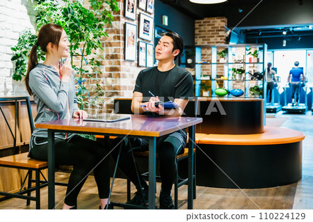 A woman receiving membership information at a sports gym A woman receiving membership information at a sports gym 110224129