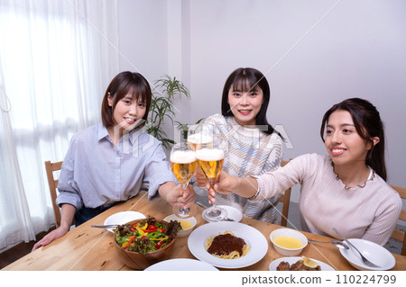 Three women toasting, girls' party 110224799