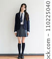 High school girl standing in front of school 110225040