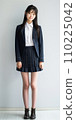 High school girl standing in front of school 110225042