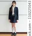 High school girl standing in front of school 110225043