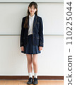 High school girl standing in front of school 110225044