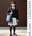 High school girl standing in front of school 110225045